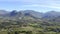 Drone, mountains and farm in summer, landscape and outdoor for growth, ecology or environment. Aerial view, hill and