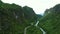 Drone, mountains and nature with road in forest for environment, countryside wildernesses and trees. Travel, river and