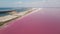 drone moves along the pink lake and blue sea