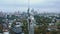 Drone moves around famous epic Motherland monument in Kyiv Ukraine looking over cinematic city and Dnepr river panorama.