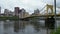 Drone moving up looking at the 7th street bridge and the city of Pittsburgh