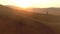 Drone, Namibia desert or man travel on sand landscape. with sunset, nature beauty on dry land, horizon or Africa. Hill