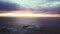 Drone, ocean and sunset with rocks, nature and clouds with horizon, seascape and waves in environment. Water, sea or