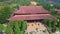 Drone opens overview religious temple against hills plants