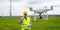 Drone operated by construction worker inspecting wind turbine