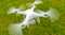 Drone operated by construction worker inspecting wind turbine