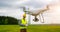 Drone operated by construction worker inspecting wind turbine