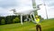 Drone operated by construction worker inspecting wind turbine