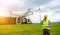 Drone operated by construction worker inspecting wind turbine