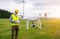 Drone operated by construction worker inspecting wind turbine