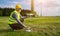 Drone operated by construction worker inspecting wind turbine