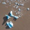 Drone overhead view of blue icebergs in the Fjallsarlon glacier lagoon, southern Iceland. The surrounding water is brown due to