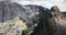 Drone panning left above amazing cinematic grey mountain rock ridges at summer Yosemite, USA national park skyline.