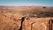 Drone panning left above breathtaking flat top mountains to reveal amazing panorama of American sunny canyon ridge.