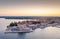 Drone panorama of Croatian coastal town Porec with harbor and promenade during sunrise