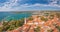 Drone panorama over the roofs of the Croatian coastal town of Novigrad with harbor and church during daytime