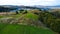 Drone panorama of spring landscape of evergreen forest and mountains with dramatic sky