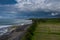 Drone panoramic view of Balinese rice fields and volcanic beach