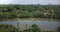 Drone panoramic view of beautiful rainforest river flowing in jungle wilderness with small boat and tropical green trees