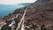 Drone perspective over Ormos Soudas near Chania. Road leading through wild hills of Greek coastline. Beautiful weather.