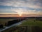 Drone photo of empty road leading through the rural village - colorful autumn sunset