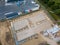 Drone photo of a large construction site on which a factory building is being erected. The foundations for the piers have been