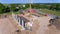 Drone photo of a large construction site on which a factory building is being erected. The foundations for the piers have been