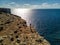 Drone photo - A woman atop the cliffs of Comino Island, Malta