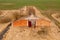 Drone photography of old abandoned and ruined rural building during spring day