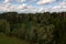 Drone photography of a pile of logs near a rural dirt road and logging site