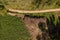 Drone photography of a pile of logs near a rural dirt road and logging site