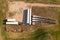 Drone photography of wind turbine parts in the middle of rural field