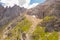 Drone pint of view of mountain rock slide and hiking path through it