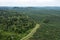 Drone point if view of palm oil plantation at the edge of tropical rainforest