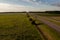 Drone point of view of dividing fence between highway and agriculture field