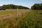 Drone point of view of dividing fence between highway and agriculture field