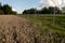 Drone point of view of dividing fence between highway and agriculture field