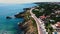 Drone point of view road leading through rocky coastline