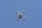 Drone quad copter in blue sky background.