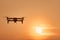 Drone quad copters with high resolution digital camera flying aerial over sunset orange sky