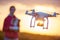 Drone quadcopter flying at sunset