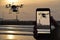 Drone quadrocopter, remote control from smartphone , sunset over the sea whit watchtower background