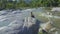 Drone Removes from Girl Silhouette on Boulder under Sunlight