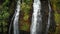 Drone rises above a high waterfall on a cliff Opaekaa Falls, Kauai, Hawaii, USA