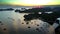 Drone Rises above Houses and Boats in Bay at Sunset