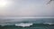 Drone rising from the ground above old wooden fence to reveal amazing coastline ocean waves panorama and skyline.