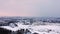 Drone rising over big working stone quarry near Regensburg, Bavaria on winter morning with snow and city in background