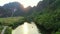 Drone, river and boat in forest, nature and mountains with sunset sky, freedom and adventure with transportation. Jungle