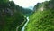 Drone, river and valley with road in forest for environment, countryside wildernesses and trees. Travel, nature and