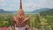 Drone rotates close to pagoda dome against tropical plants